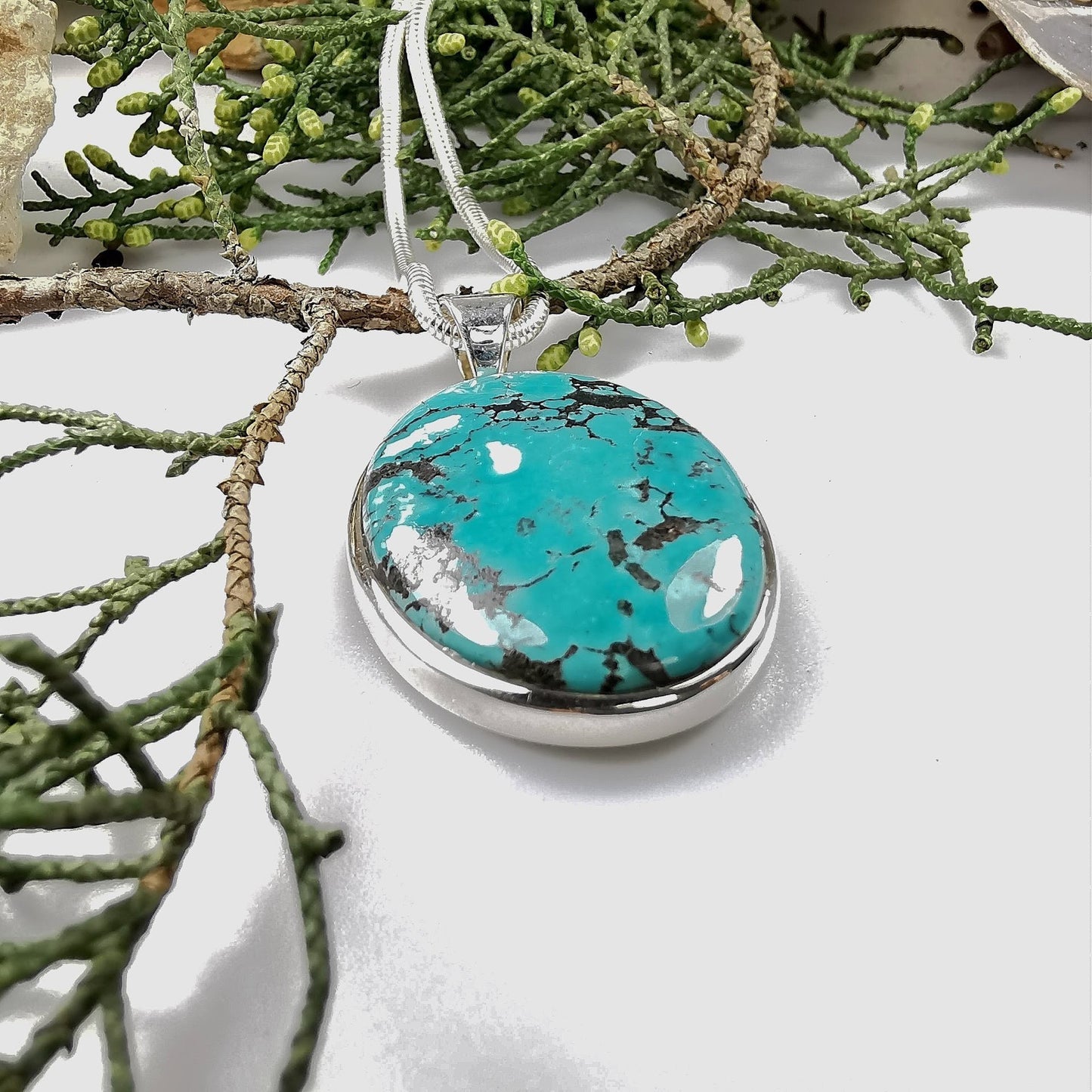 large oval turquoise pendant set in silver